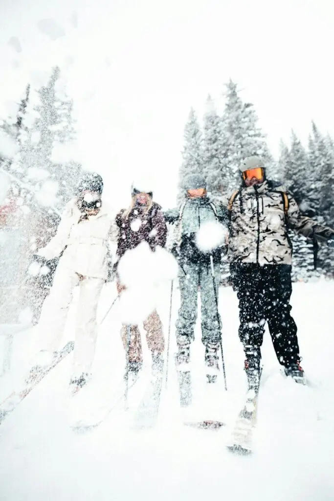 A group of people riding skis down a snow covered slope