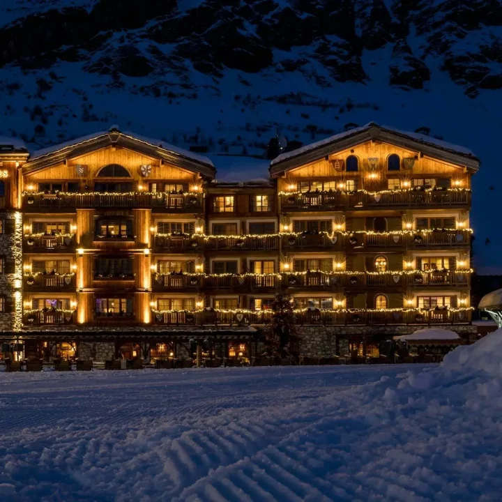a hotel lit up at night in the snow